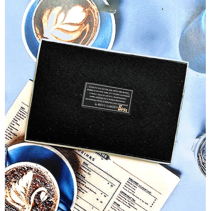 Black box with a Ben's Garden label on top of a menu with coffee-themed design