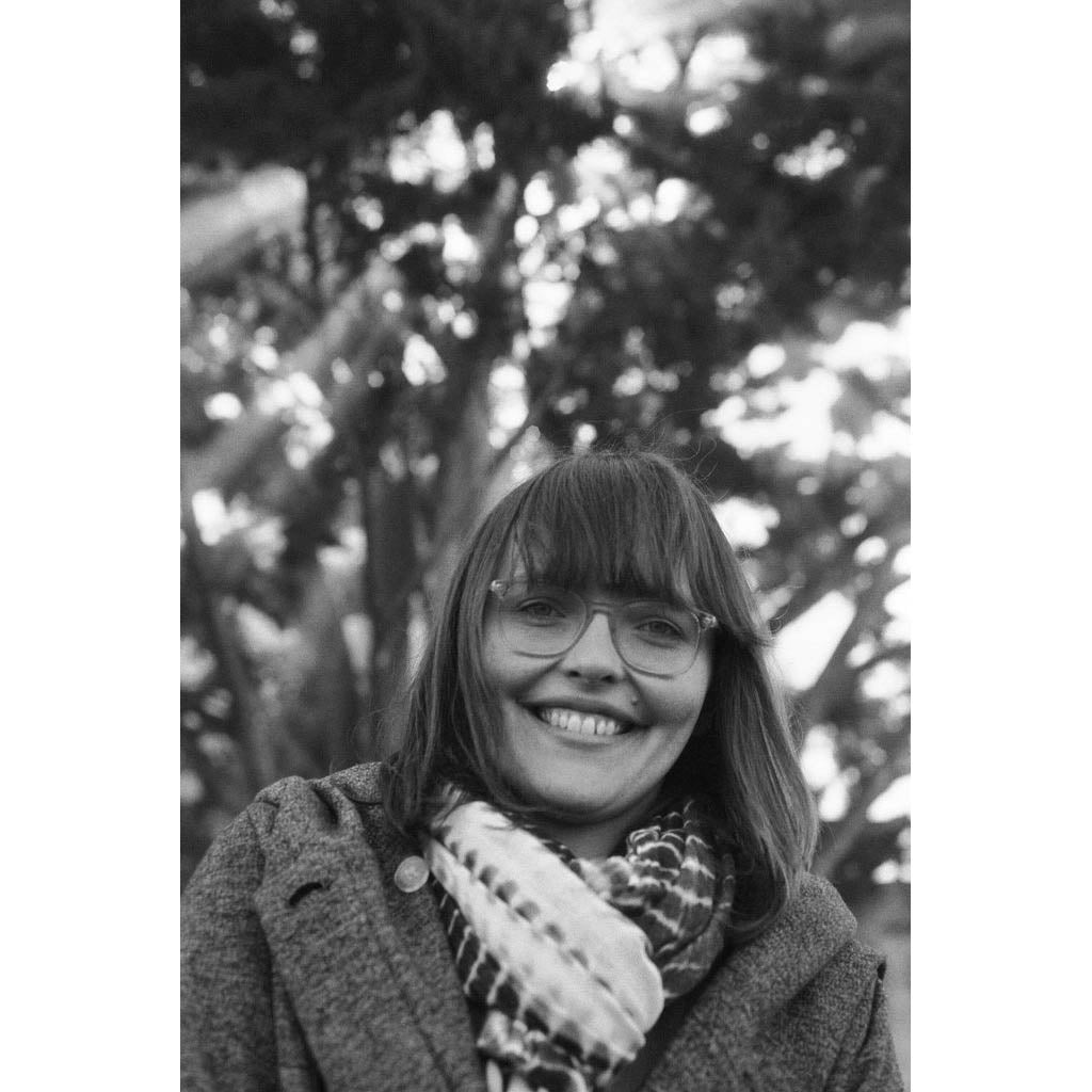 Black and white photograph of a person smiling
