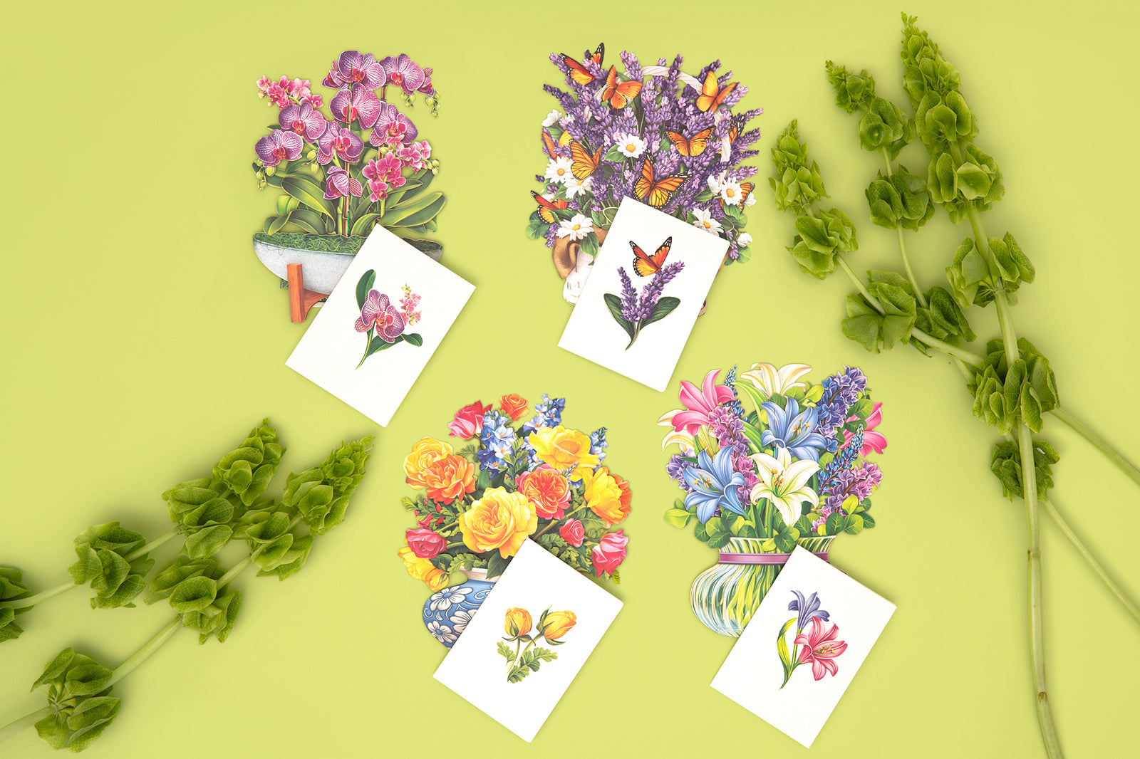 Floral illustrations on white cards with greenery on a yellow background