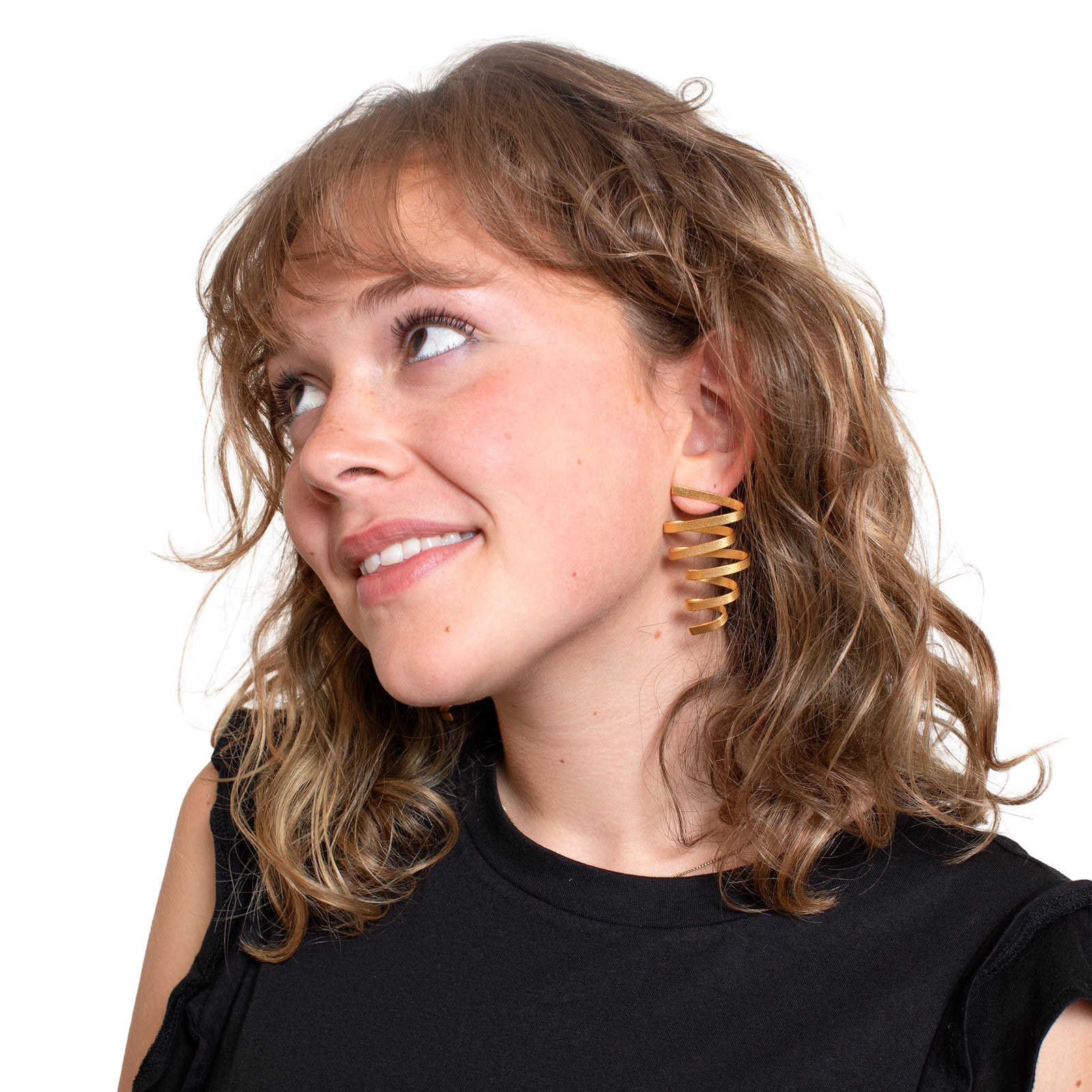 Gold spiral earrings on a white background