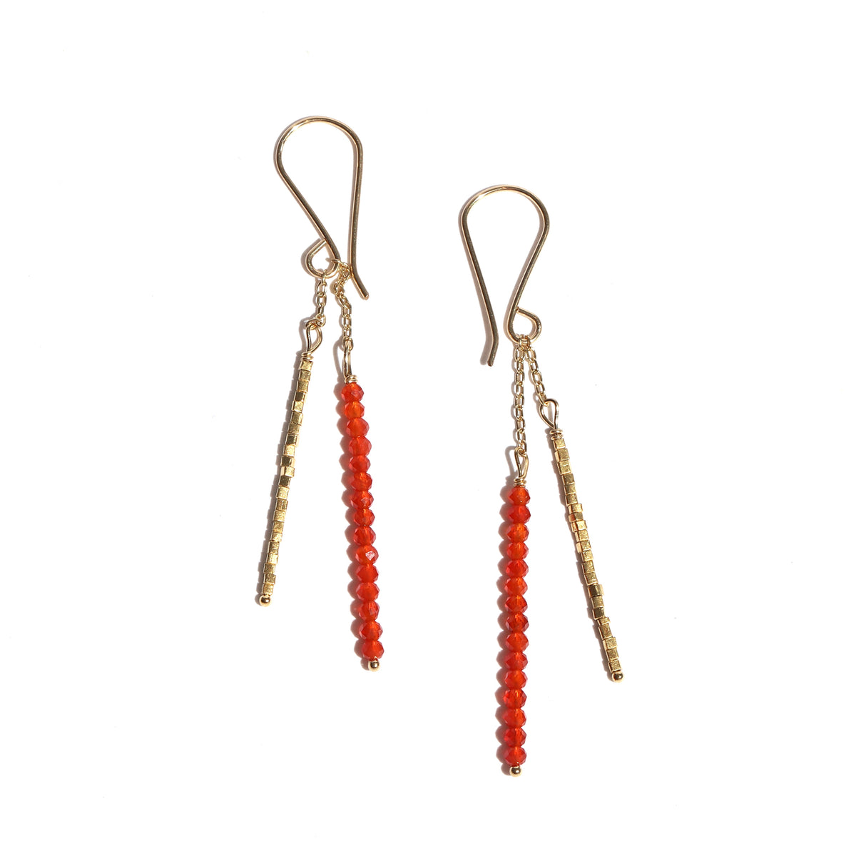 Pair of earrings with gold and red beads on a white background