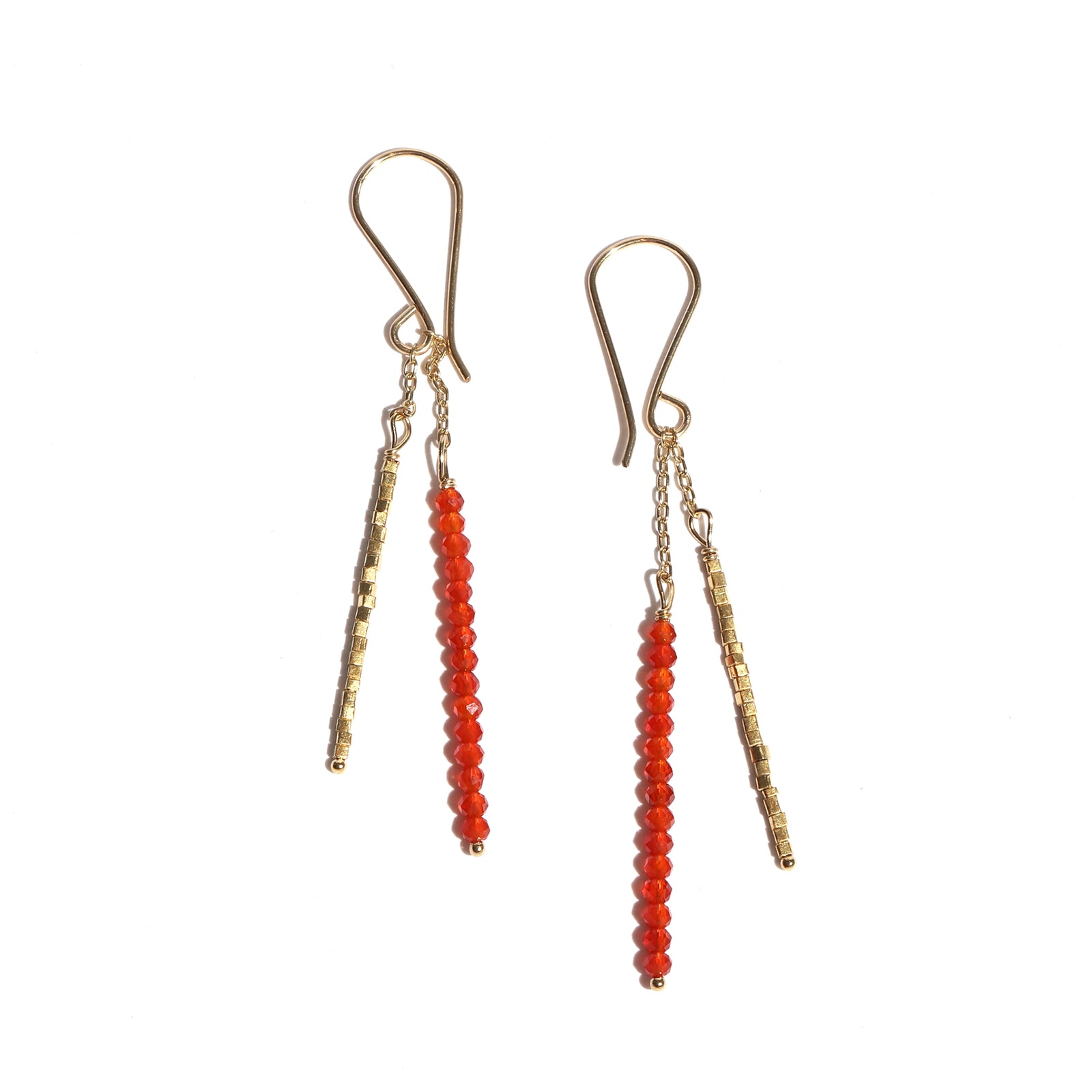 Pair of earrings with gold and red beads on a white background