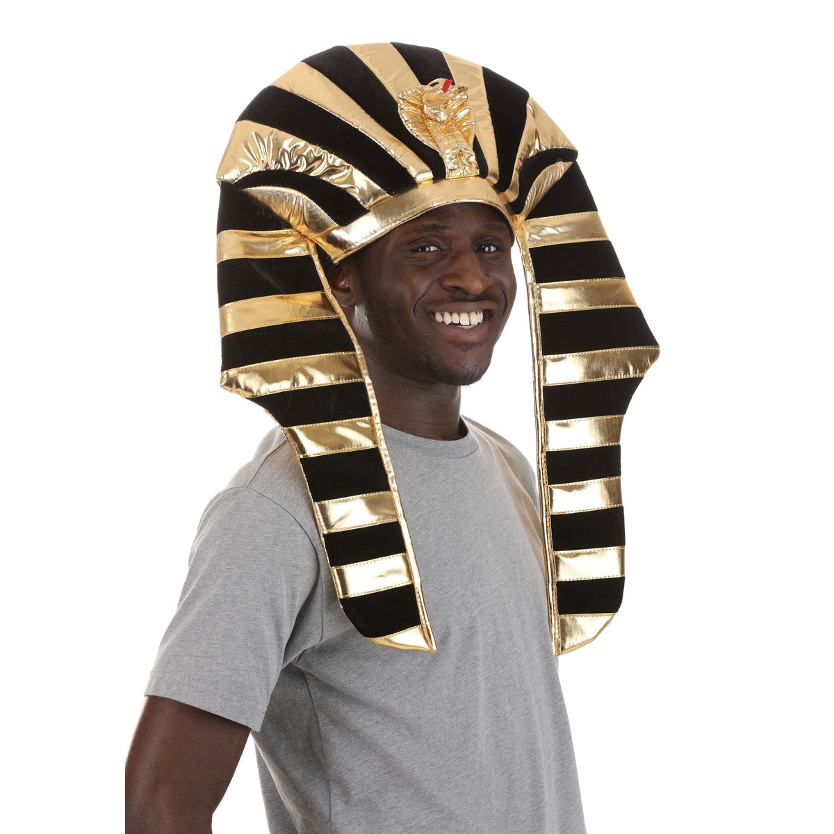 A man wearing a shiny gold and black striped Egyptian pharaoh costume headdress, paired with a gray t-shirt, against a plain white background.