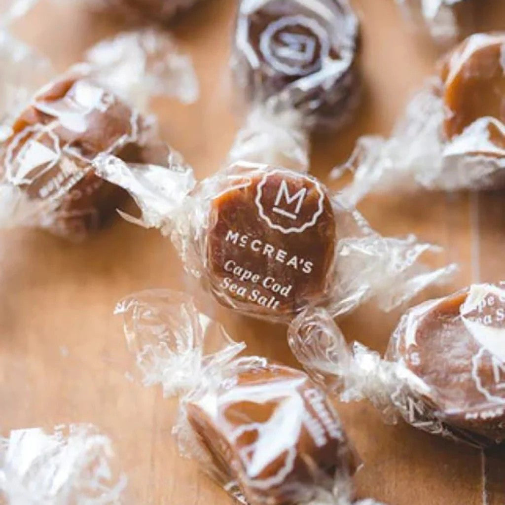 Cape Cod Sea Salt candy with Mccrea&#39;s branding on a wooden surface