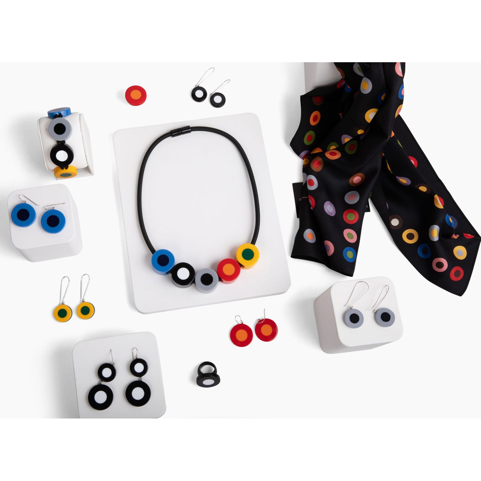 A black and white resin ring with a flat, circular bead.