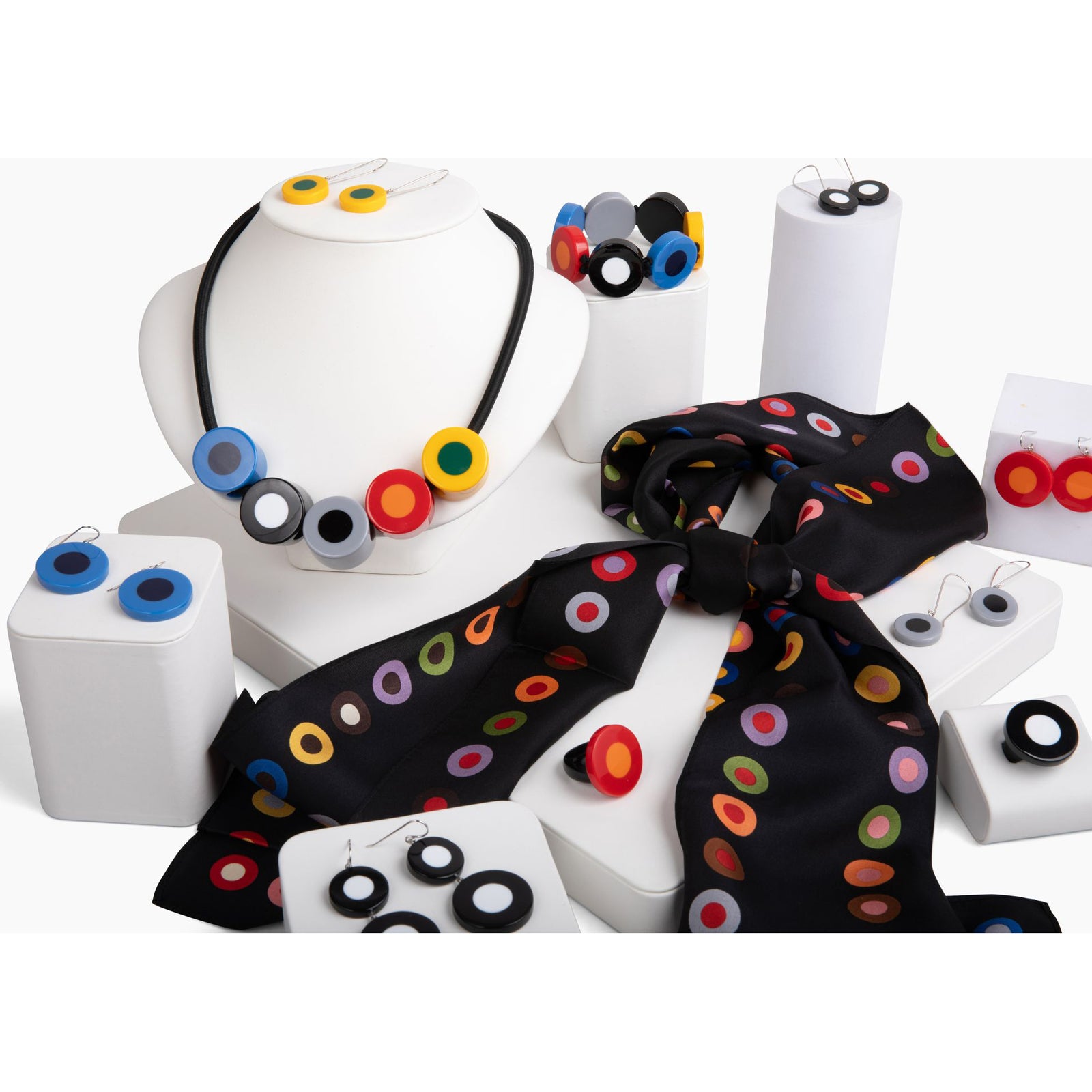 A pair of blue dot pattern resin earrings attached to sterling silver hooks.