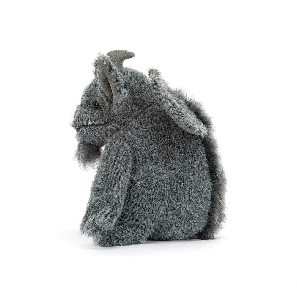 A gray plush monster toy with textured fur, small horns, and large floppy ears, shown from the side on a clean white background.