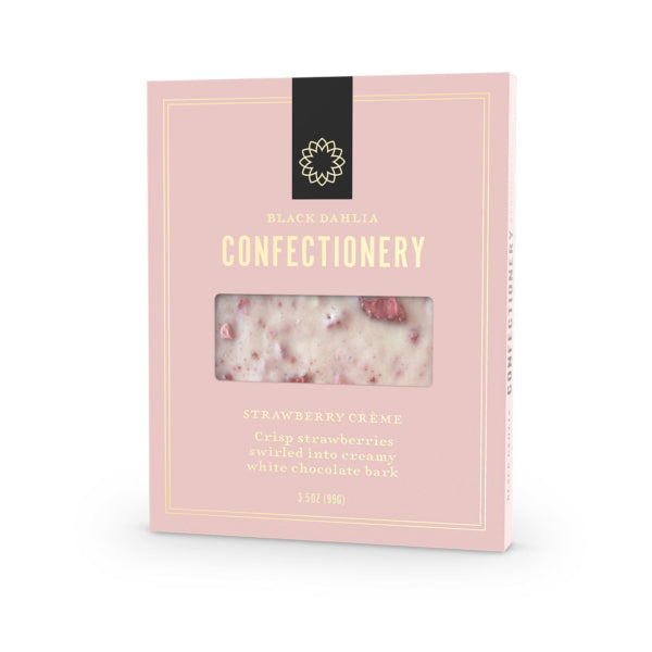 Pink packaging of Black Dahlia Confectionery with a window showing strawberry cream and white chocolate bark.