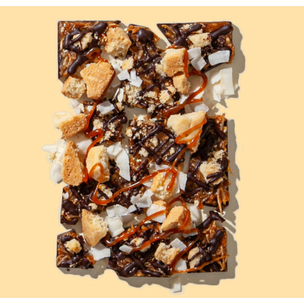 Chocolate dessert with crumbled cookies and coconut on a beige background