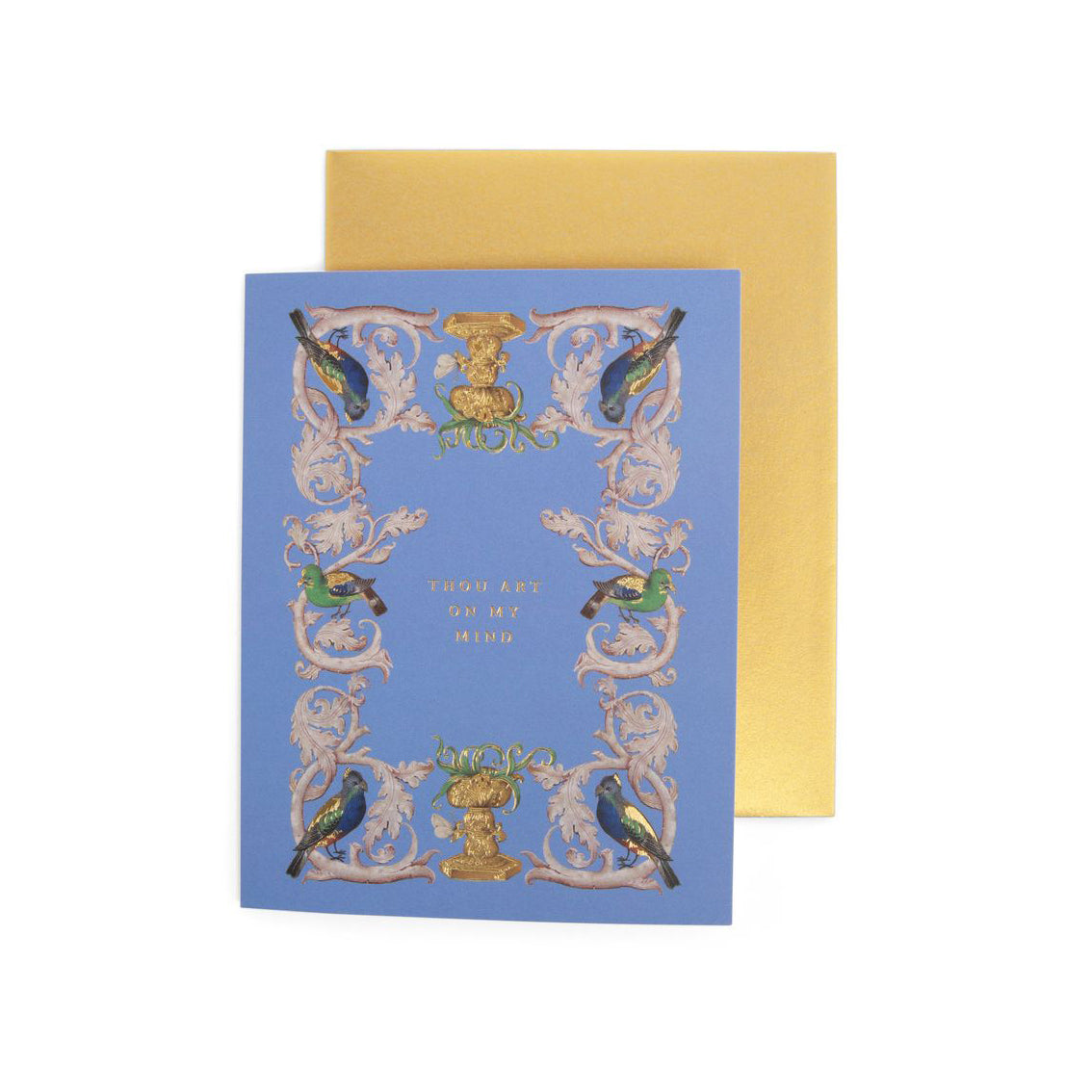 A greeting card with a medieval manuscript-inspired design, featuring birds and ornate patterns, with a blue background and a gold envelope.
