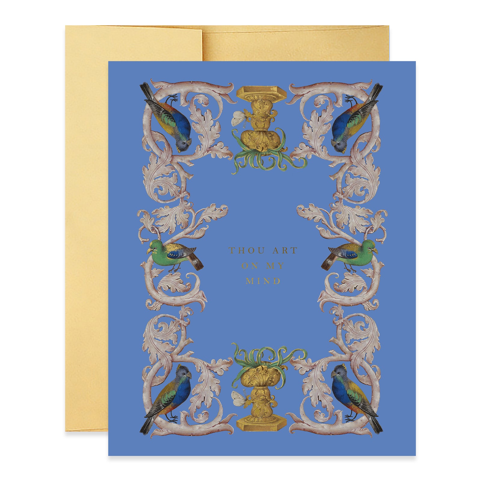 A greeting card with a medieval manuscript-inspired design, featuring birds and ornate patterns, with a blue background and a gold envelope.