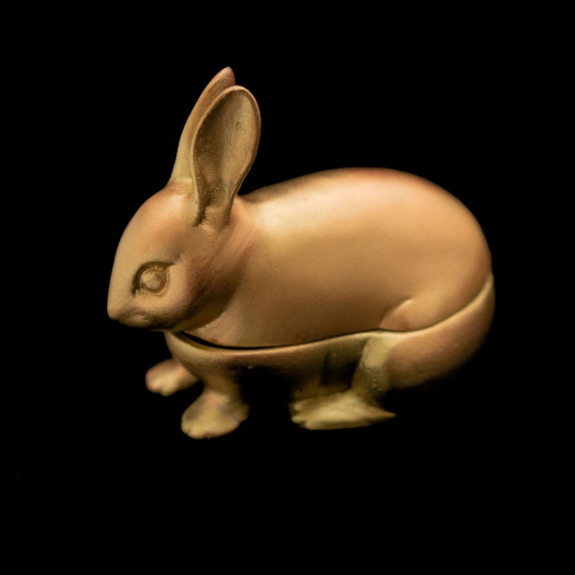 A pewter trinket box in the shape of a hare with an antique brass finish.