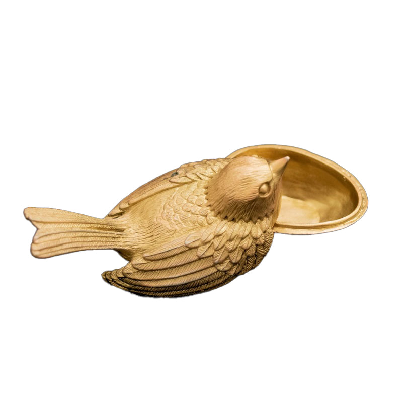 Gold bird-shaped jewelry box on a white background