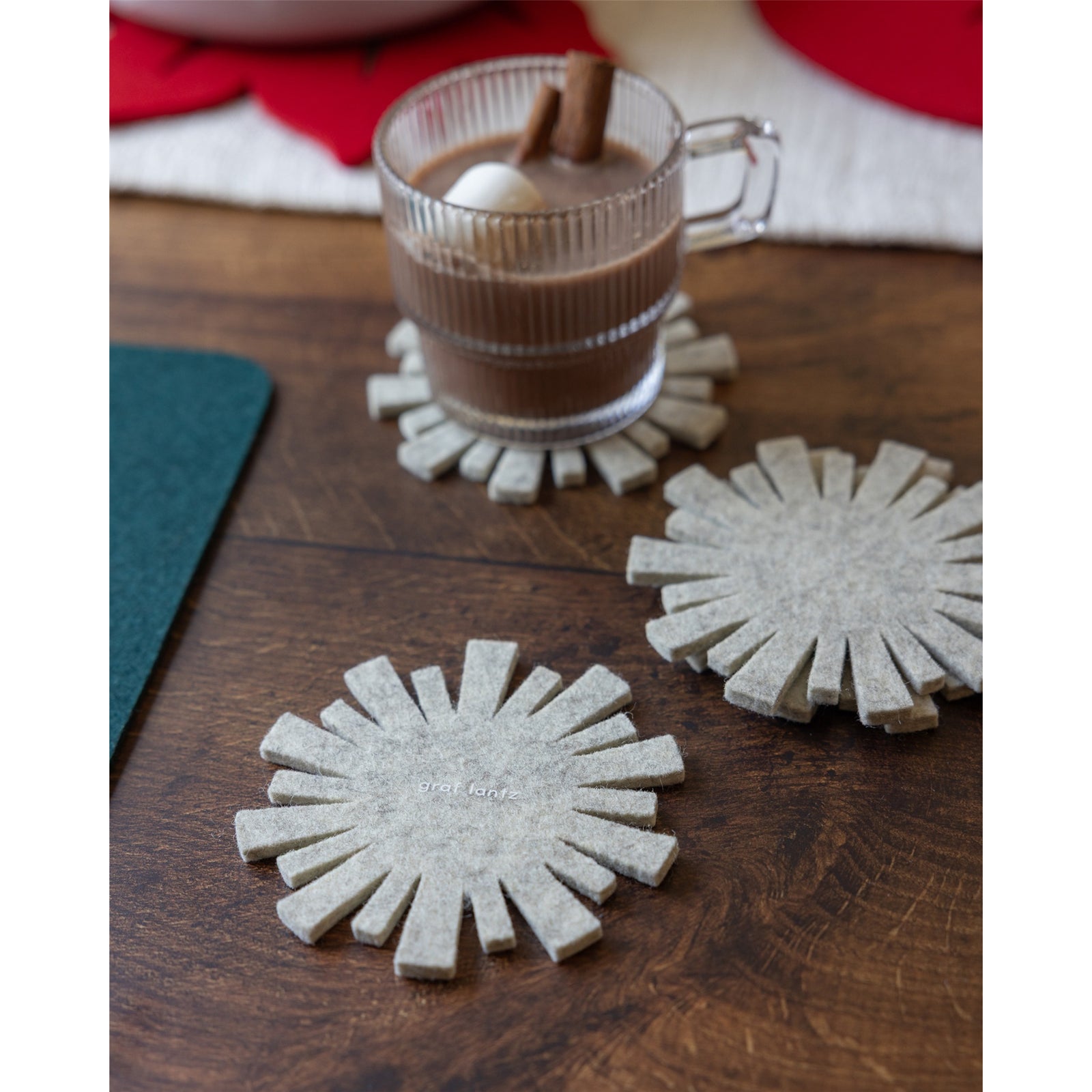 Four beige sunflower-shaped coasters on a white background