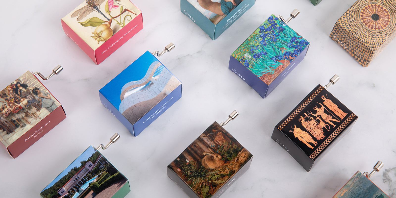 Collection of small, colorful music boxes with various designs on a light background