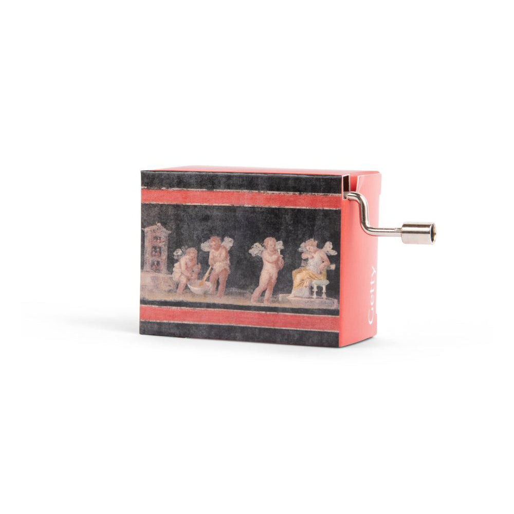 A small music box with a print of ancient Roman fresco depicting Cupids and Psyche on the front, with a hand crank on the side.