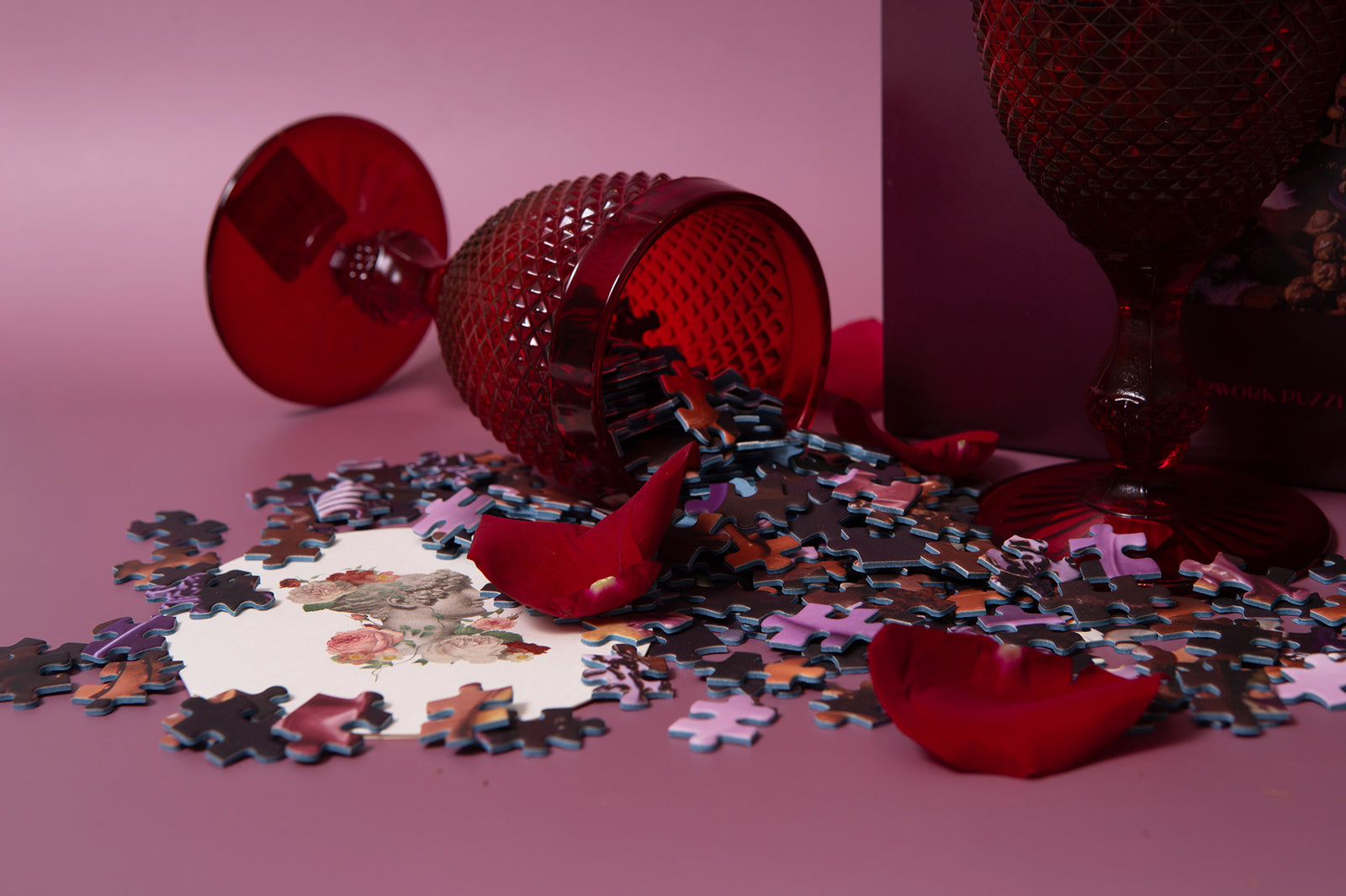 Puzzle pieces with red decorative elements on a pink background