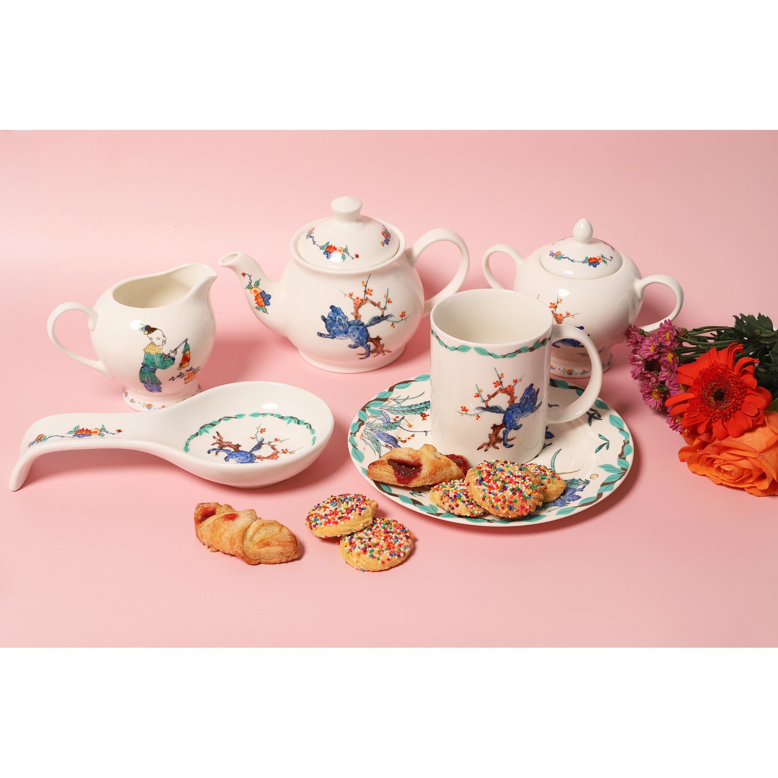 A white porcelain creamer and matching sugar bowl set with hand-painted traditional Chinese-style illustrations, shown on a plain white background.