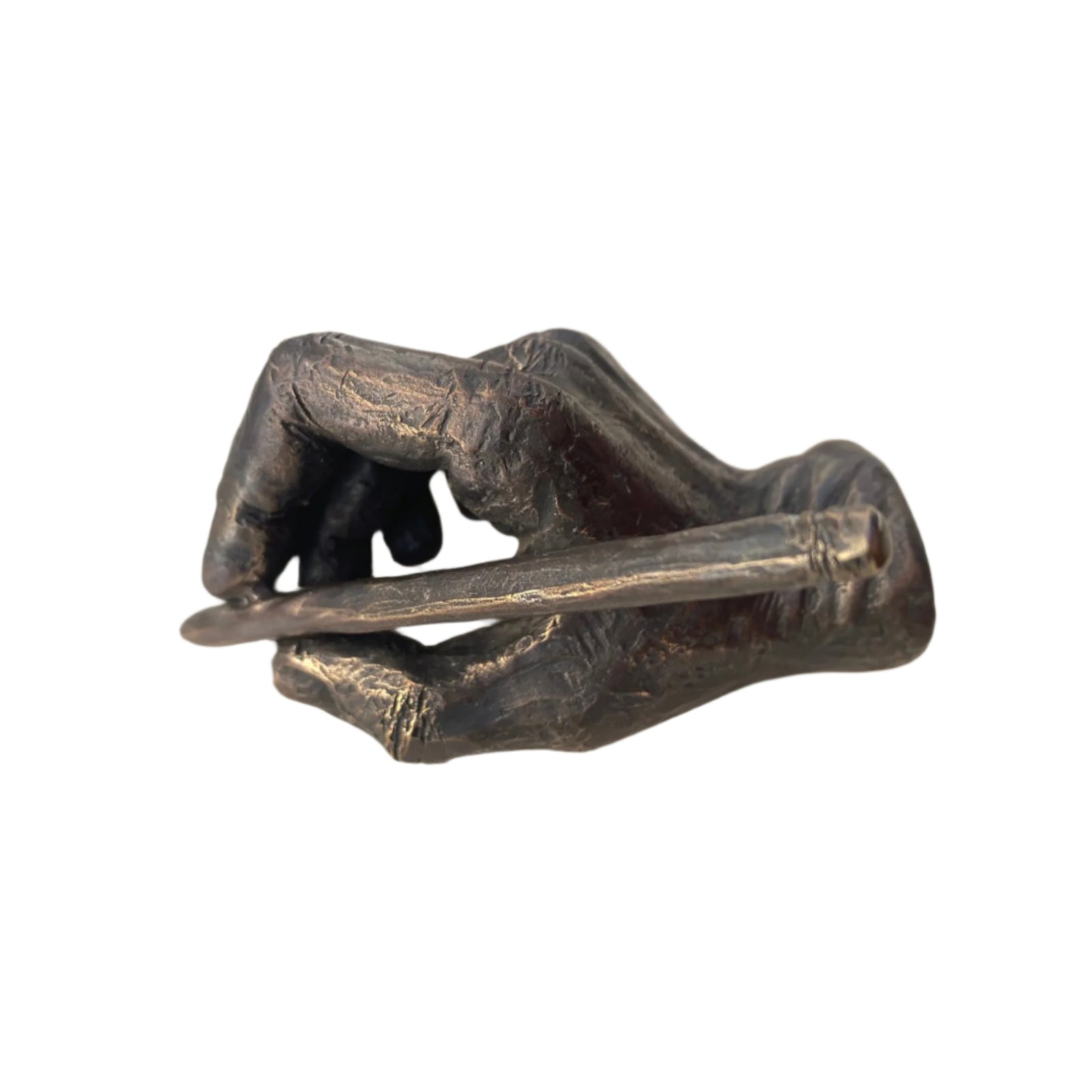 A bronze sculpture of a hand holding a pencil, symbolizing the art of writing or drawing.