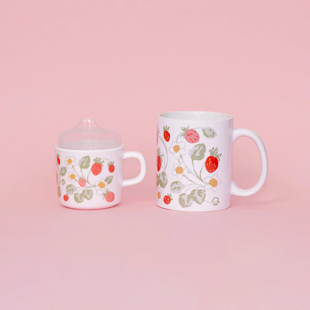 Two mugs with floral patterns on a pink background