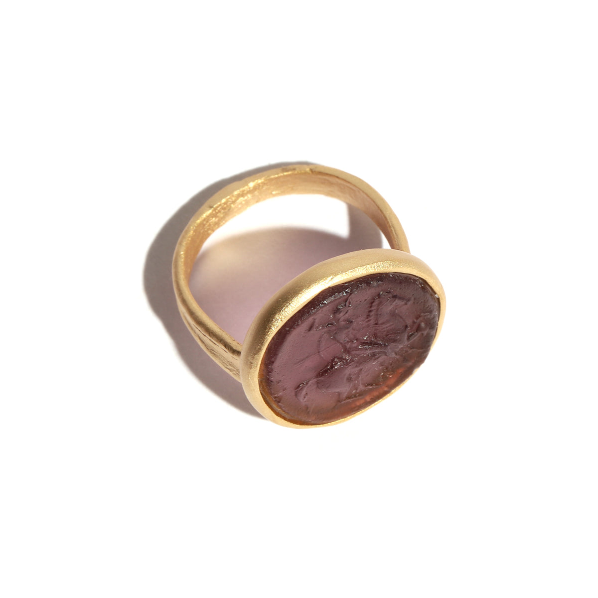 Gold ring with a glass figure on a white background