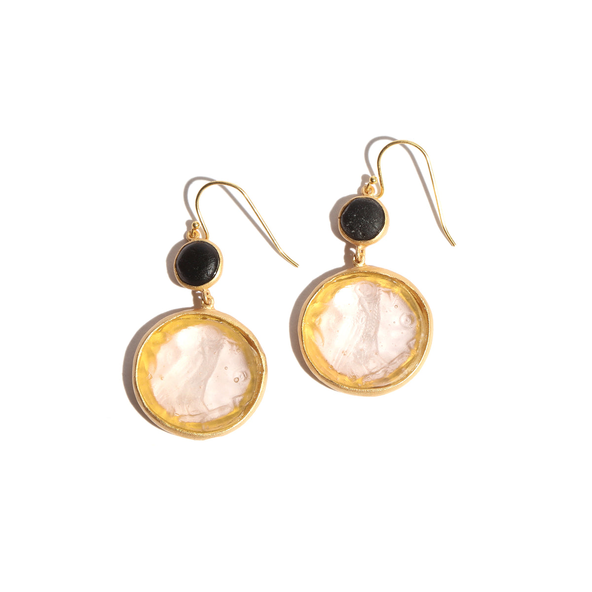 Pair of earrings with white glass and black glass on a white background