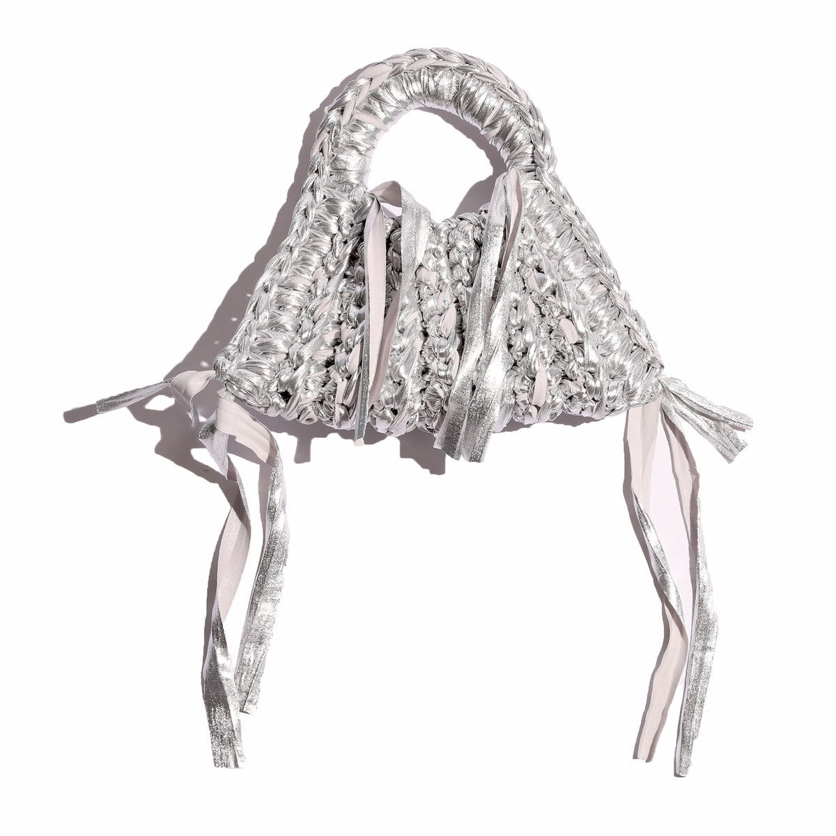 Silver woven handbag with fringes on a white background