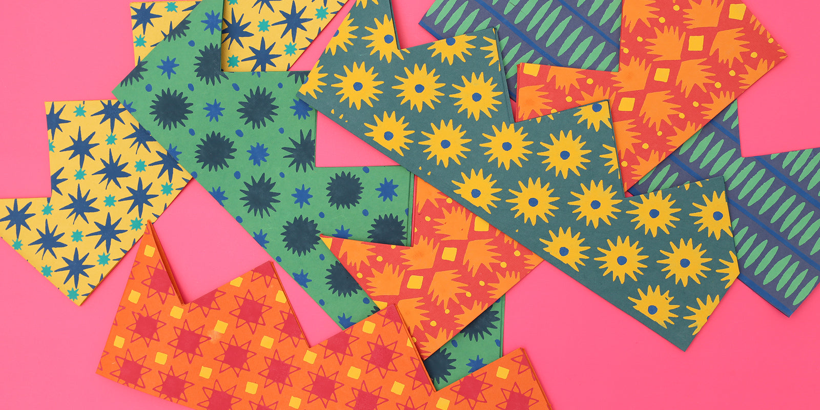 Paper crowns against a pink background