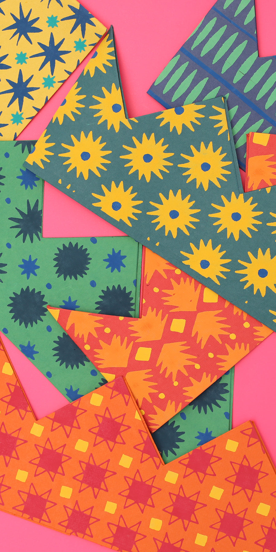 Paper crowns against a pink background