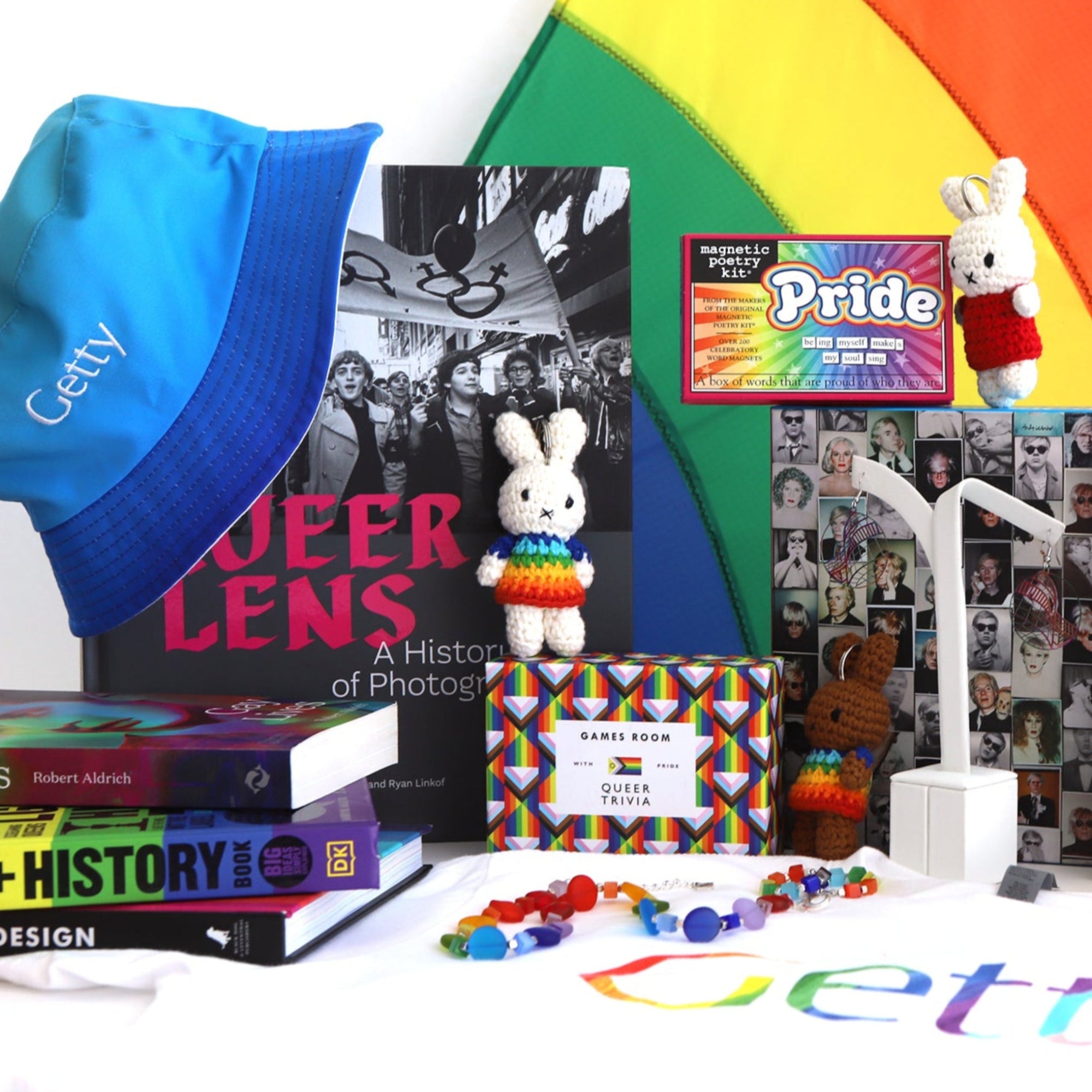 Collection of Getty products including books, hats, and toys against a rainbow background