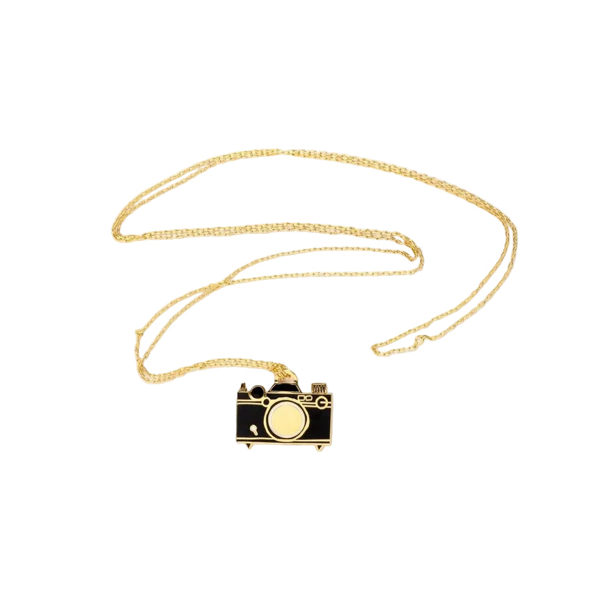 Camera-shaped pendant on a gold chain against a white background