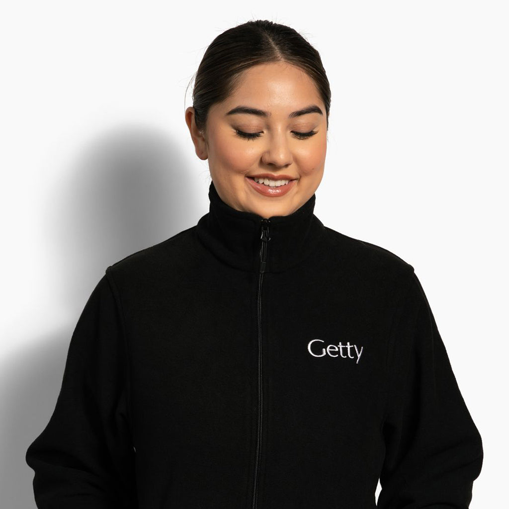 Person wearing a black jacket with 'Getty' logo on a white background