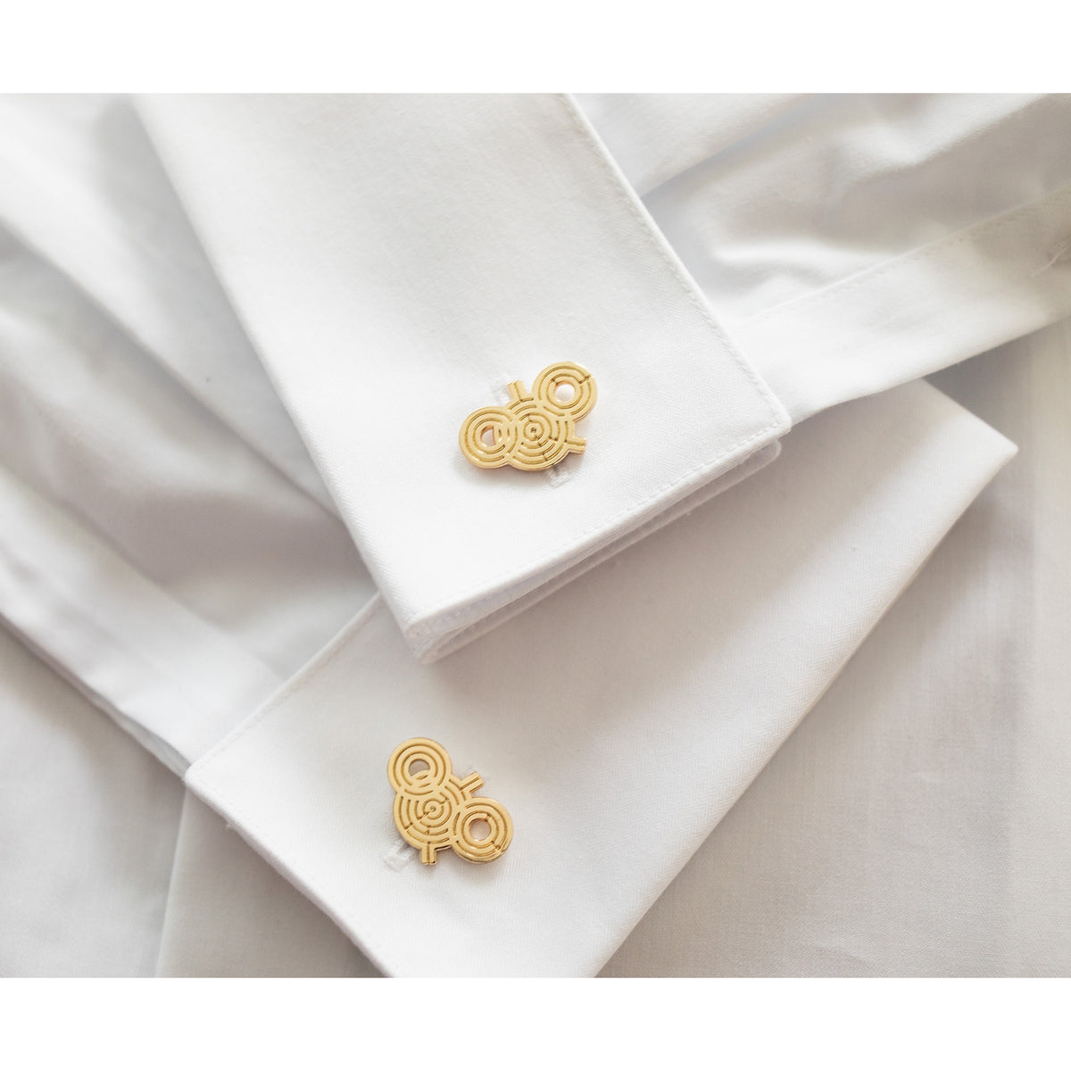 Gold cufflinks on a white shirt
