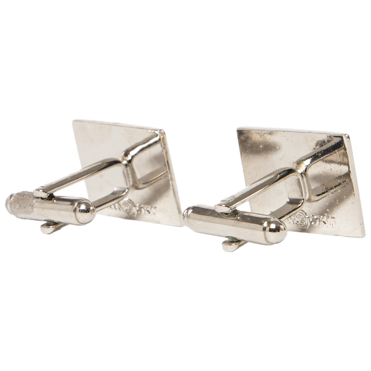 Pair of silver cufflinks on a white background