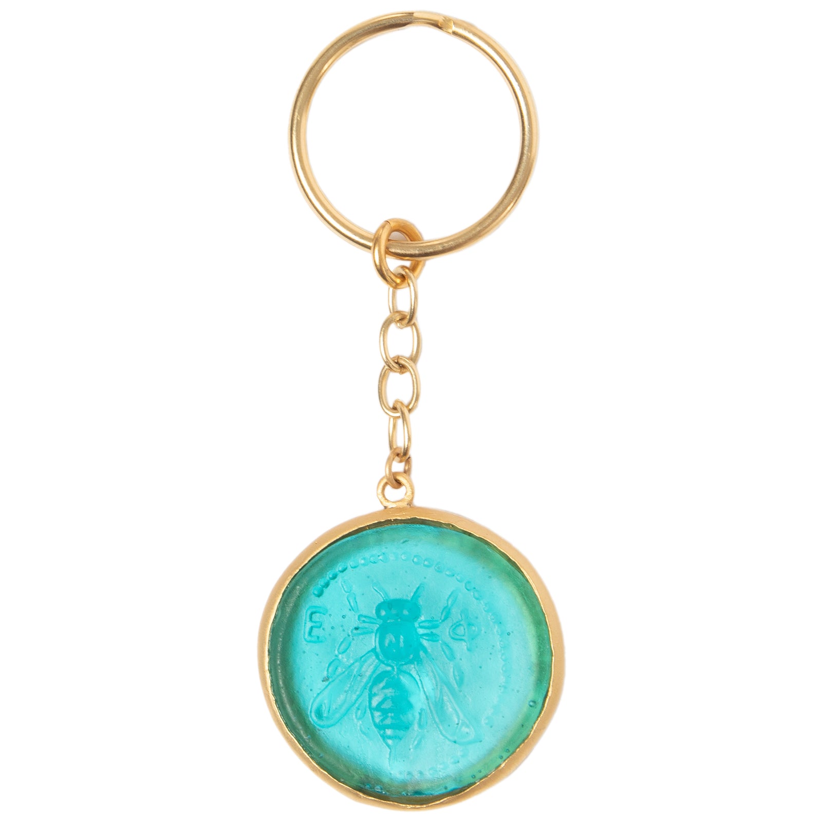 A key ring featuring a handcrafted glass coin with a teal blue color and an embossed design of a bee, surrounded by a gold-colored metal frame.