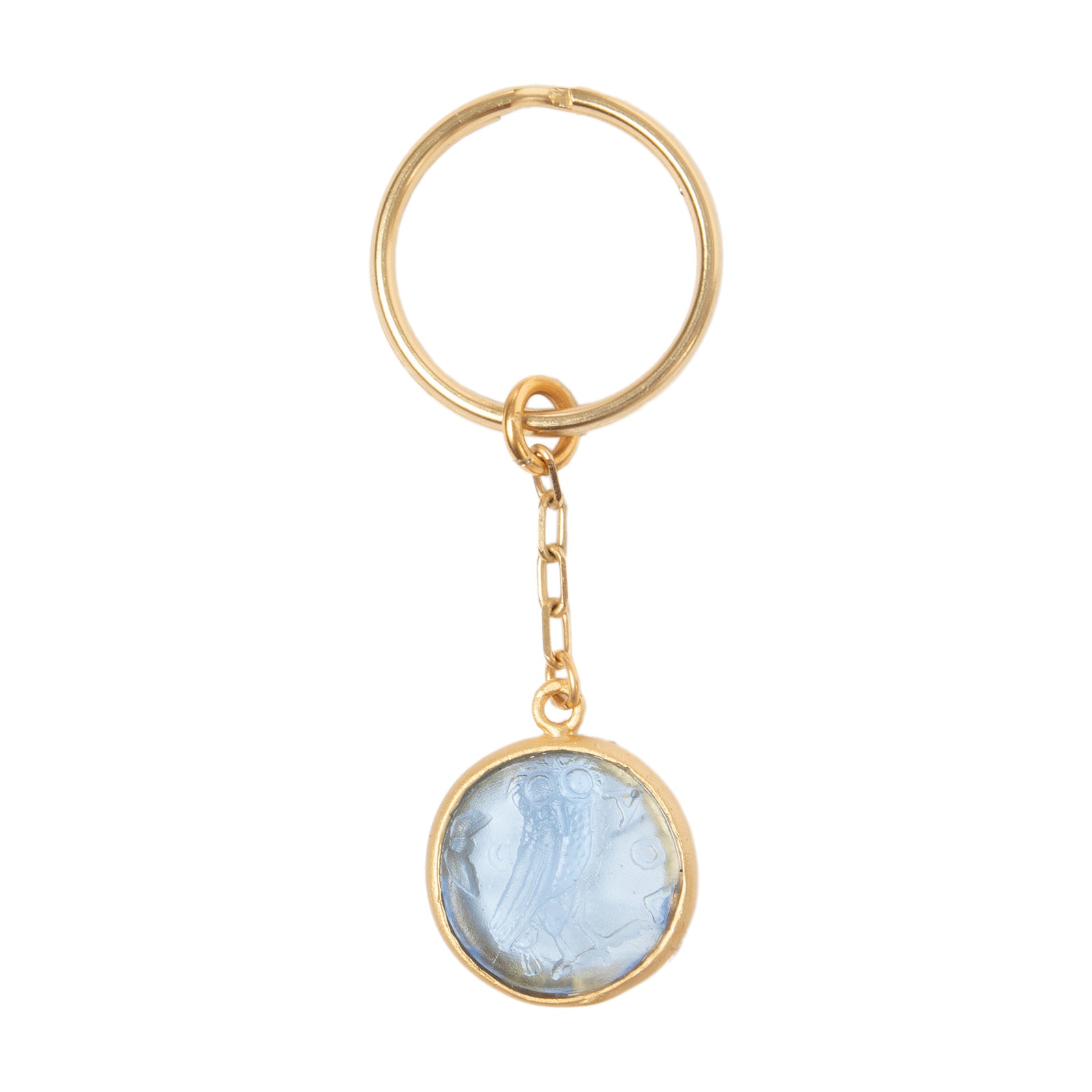 A gold key ring with a sky-blue toned handcrafted glass coin attached to it.