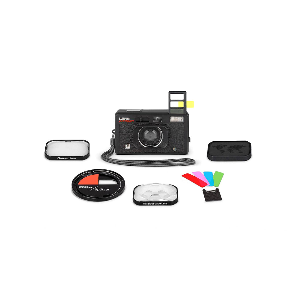 Collection of camera accessories including a camera, filters, and lenses on a white background