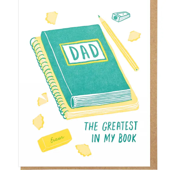 Notebook with 'DAD' on the cover and stationery items on a white background