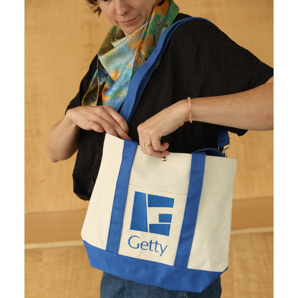 Pereson looking inside Getty G Mark Canvas Tote