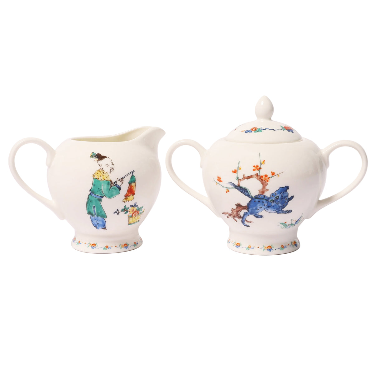 A white porcelain creamer and matching sugar bowl set with hand-painted traditional Chinese-style illustrations, shown on a plain white background.