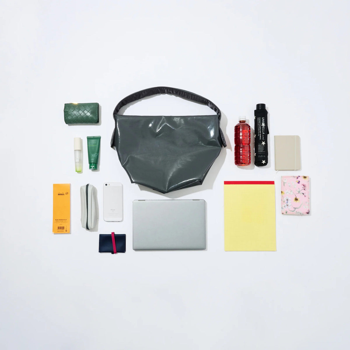 Collection of various items including a transparent bag, bottles, and containers on a white background