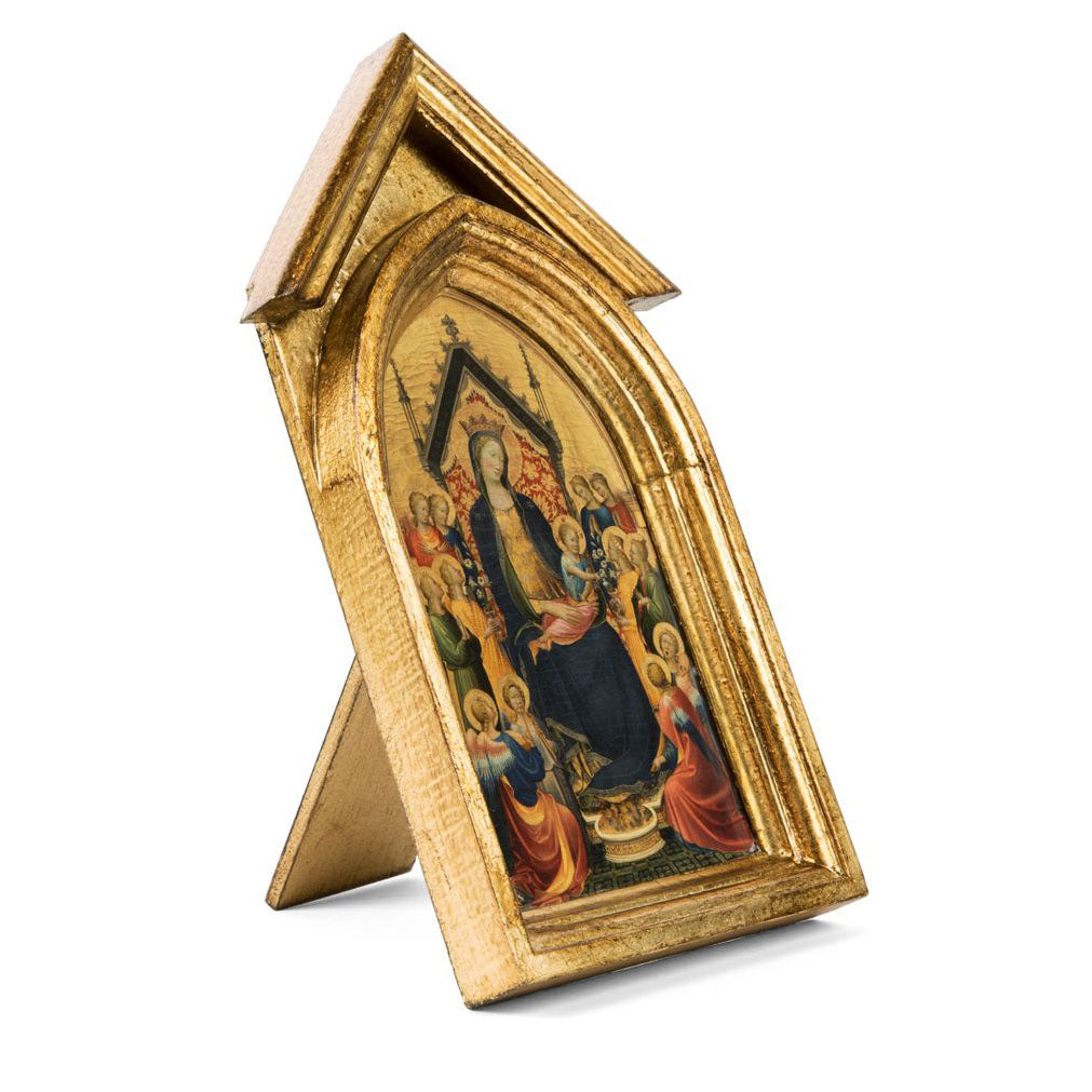 A reproduction of a medieval panel painting depicting the Madonna and Child with musical angels, encased in a wooden frame with a golden finish.