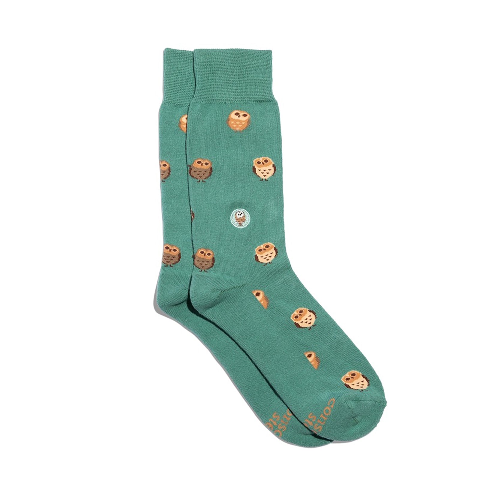 Green sock with owl pattern on a white background