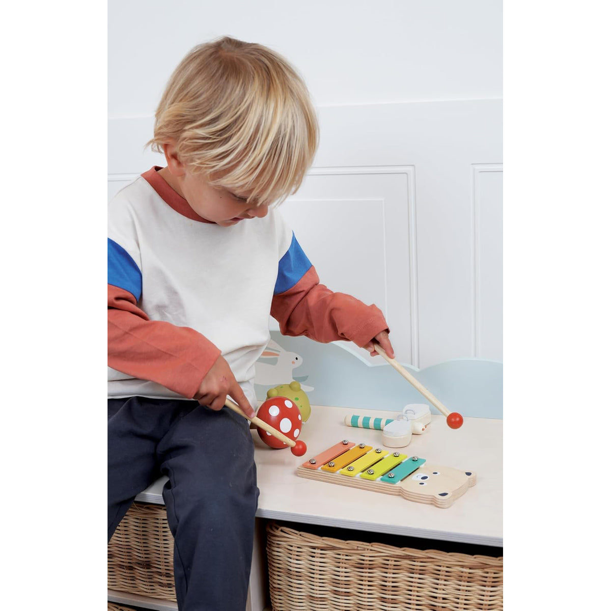 Child playing with colorful wooden toys on a table
