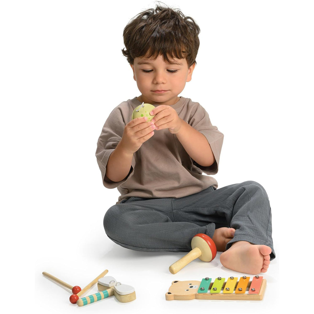Child playing with wooden toys on a white background