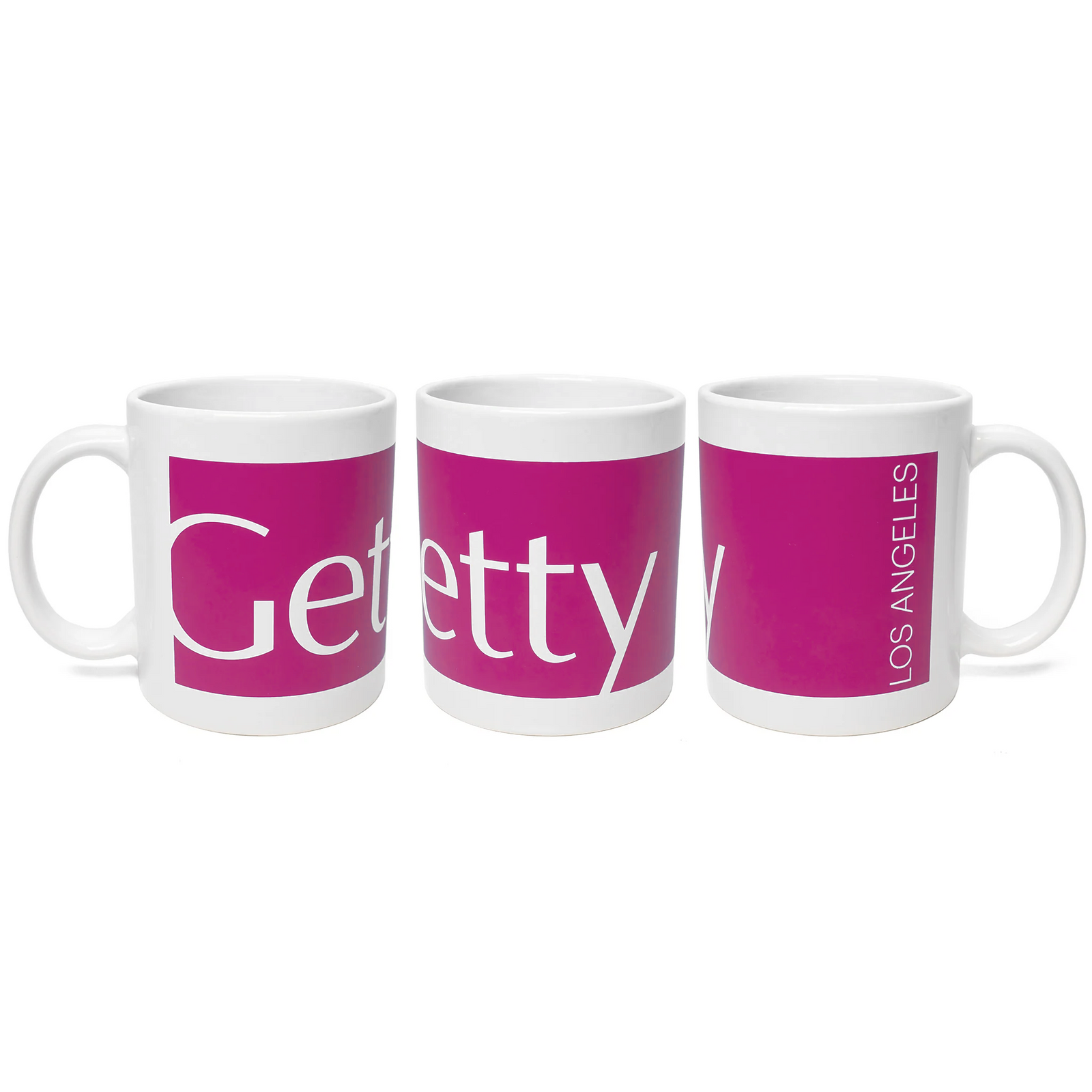 A ceramic mug with a pink stripe and the text 'Getty' and 'Los Angeles' on it, displayed in a three-position rotation.