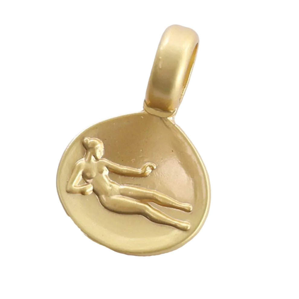 A gold pendant featuring an embossed reclining female figure on a circular disc with a polished bail at the top, shown against a plain white background.