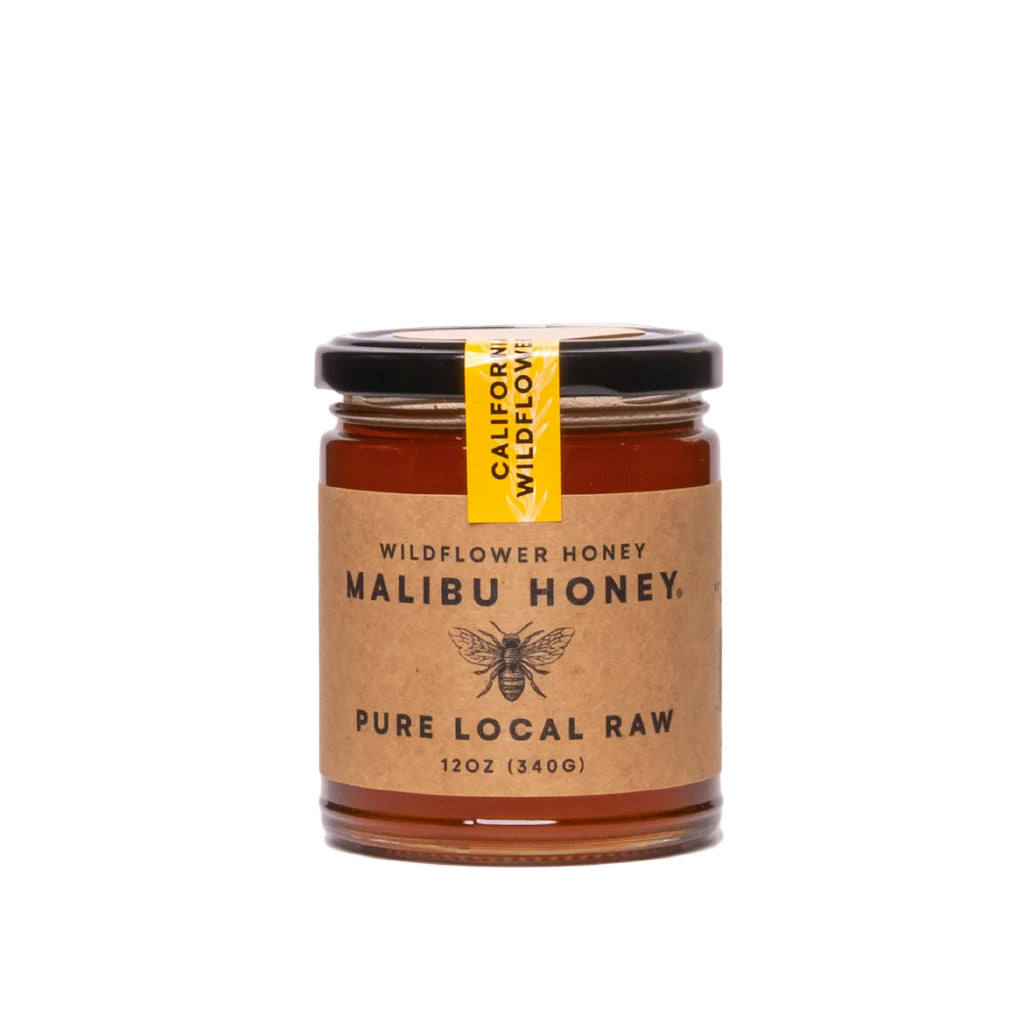 Jar of Malibu Honey with a yellow label on a white background