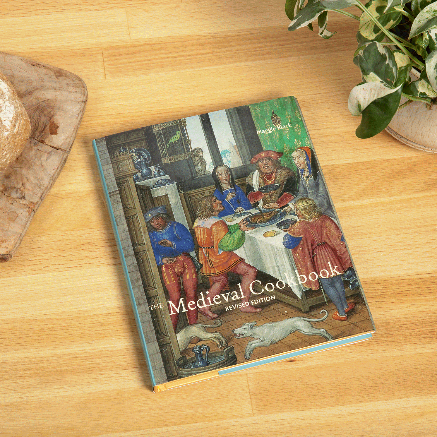 Book cover of 'The Medieval Cookbook' with historical illustration of people dining.