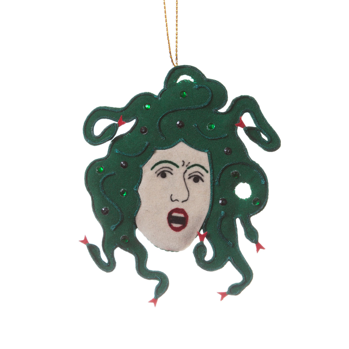 A felt Medusa head hanging ornament with dark green hair, a beige face, red lips, and small red and green rhinestone accents, suspended by a gold string on a white background.